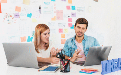 Two digital marketers brainstorming content ideas and strategies to build a dream life through online marketing skills.