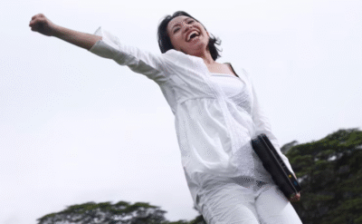 Confident woman celebrating success after learning digital marketing skills for personal and professional growth.