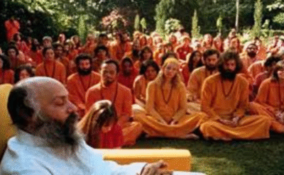 Osho meditating with disciples at Pune Commune