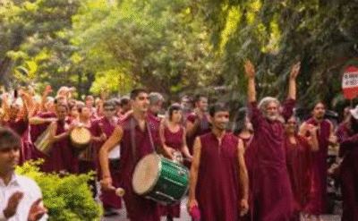 Osho followers in maroon robes celebrating death as a joyful event in line with his spiritual teachings